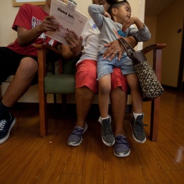 Mo and two kids sitting in a waiting room