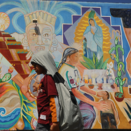 A child walks in front of a mural