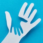A cartoon image of a child's hand over and adult hand
